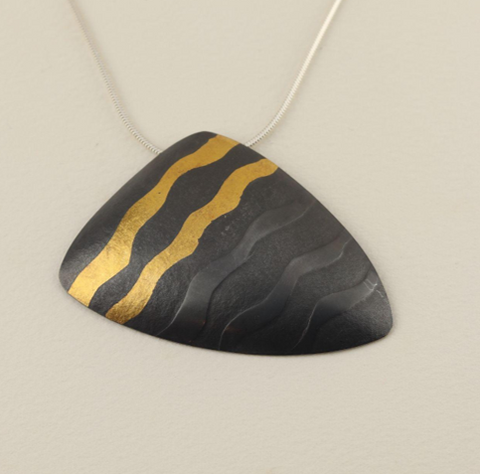 Sandra Elizabeth 'Shell Form Pendant' oxidised silver with gold waves