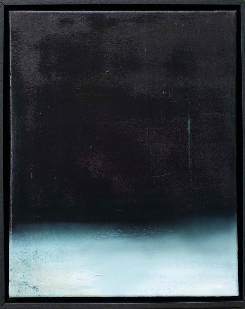 An abstract framed painting featuring a dark, textured black upper section that gradients into a misty, pale blue-white lower section, enclosed in a thin black frame.