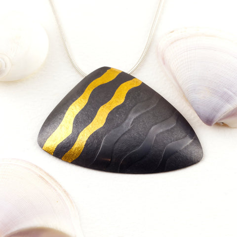 Sandra Elizabeth 'Sterling silver shell form pendant with 24 carat gold wave, and oxidised finish' 40x53mm