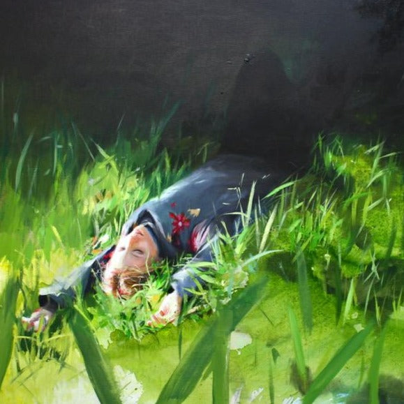 Susana Ragel at Iona House Gallery - girl lying down sleeping on new, fresh long grass, her face is in the sunlight, arms above her head, her body is disappearing into the shadows.
